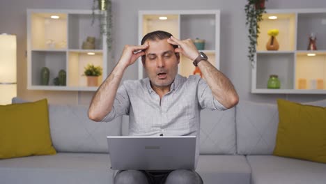 Man-working-on-laptop-has-a-headache.